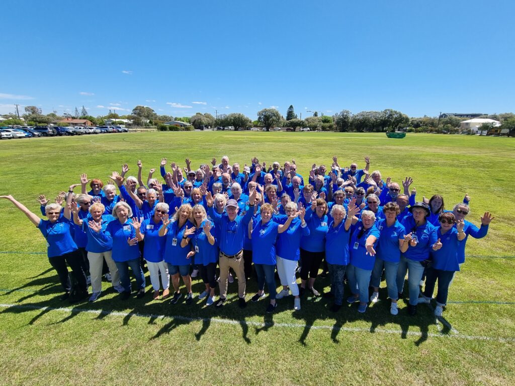 All Busselton Jetty volunteer Jetty Hosts posing for a group photo with their Blue Volunteer uniforms on.