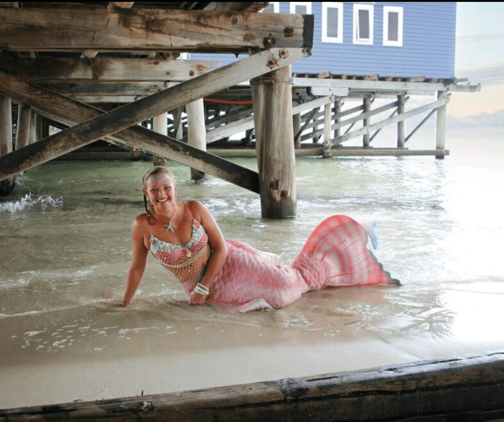 Mermaid under Jetty out of the water