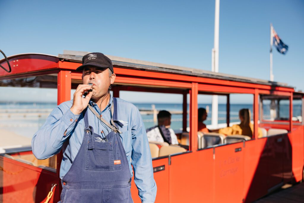 Train Driver blowing his whistle to signal the departure of the Jetty Train from the shore.